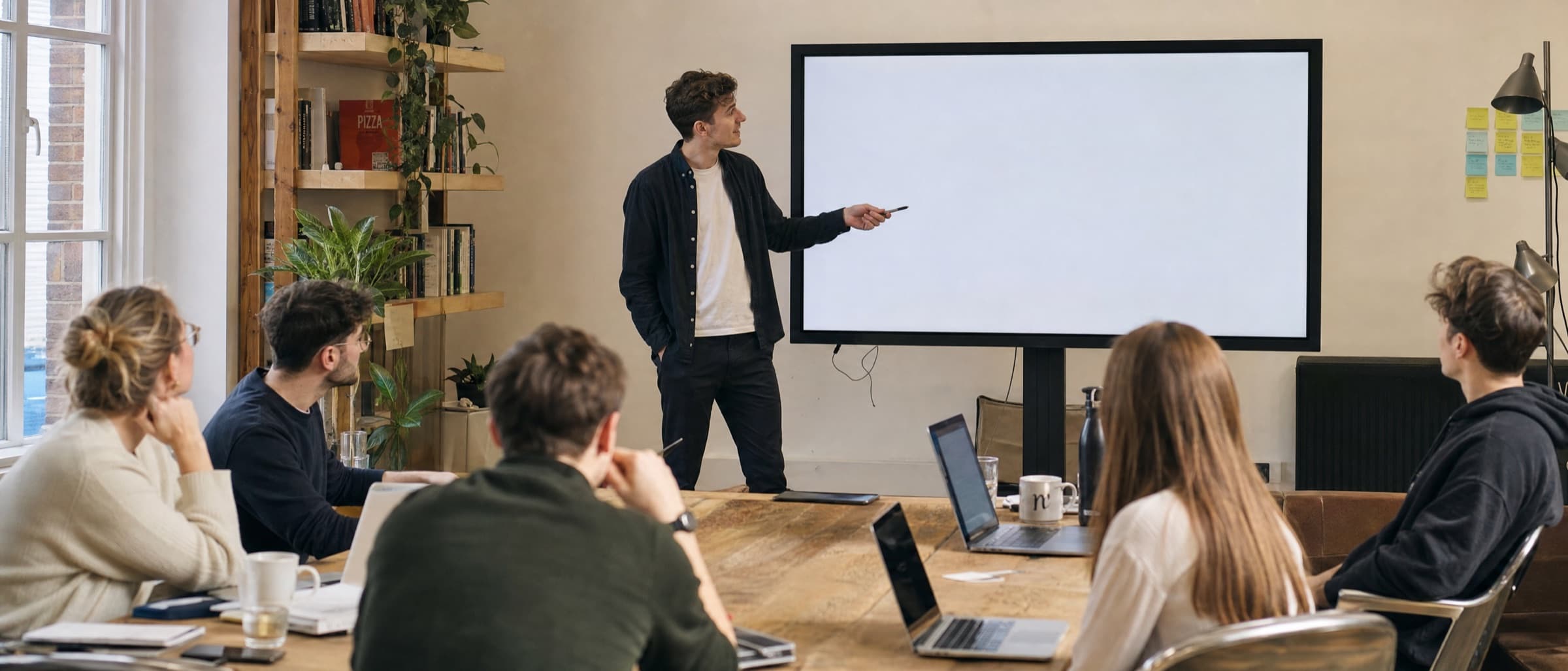 An informal in-house training session in front of a shared screen