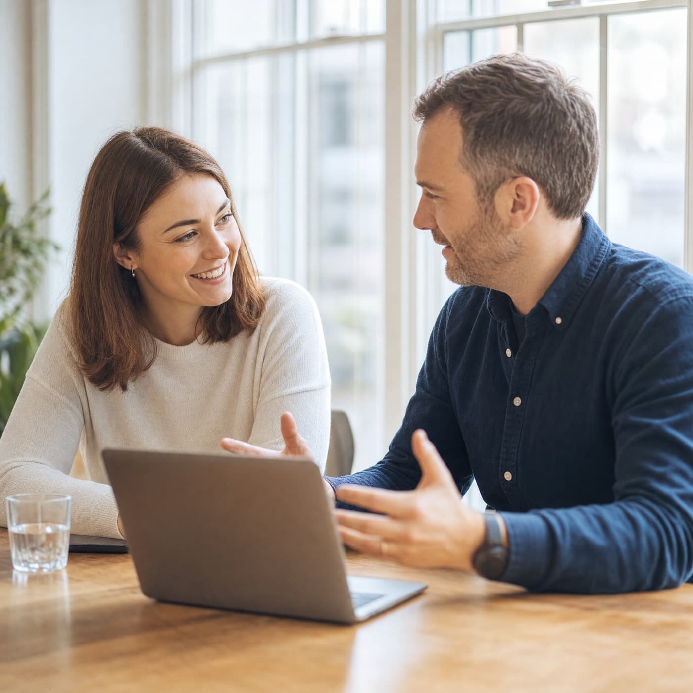A consultant sitting beside a client, talking them through the work
